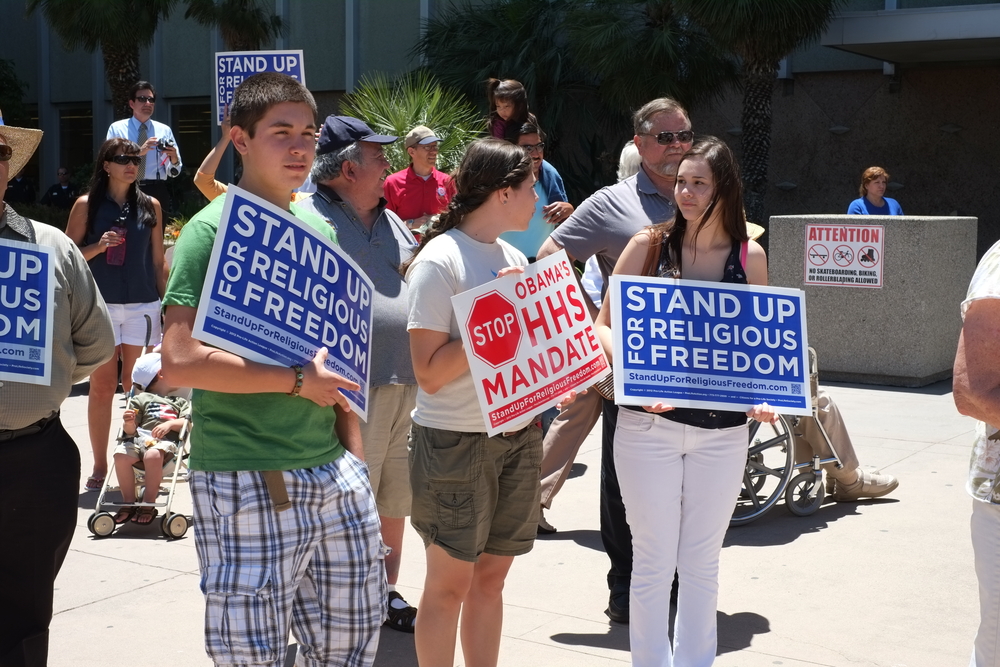 Unidentified participants show protest signs at the Stand Up for Religious Freedom Rally in Bakersfield, CA.
