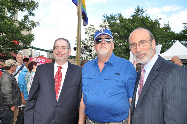 Gilbert Baker, the creator of the Pride Flag, attends a flag raising ceremony at the US Embassy in Canada with Consul General Andrew Parker and Deputy Chief of Mission Richard Sanders.