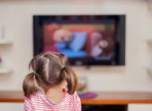 Children’s TV Show Features Same-Sex Relationship A photo of a young girl in pigtails watching a TV show.