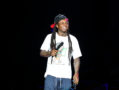 Lil Wayne Officiated a Gay Marriage During Jail Stint A photo of Lil Wayne performing on stage.