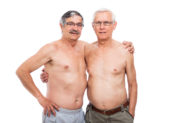 Elderly LGBTQ+ People Face Unique Problems Two elderly, gay, shirtless men pose for a picture together.