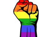 The Trump Presidency Means A Four-Year Battle for LGBTQ+ Rights A fist decked out in rainbow colors.