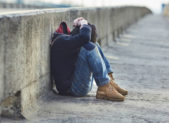 Outlast Youth Wants to Dramatically Reduce LGBT Homelessness in Dallas by 2020 A young homeless boy sitting on the street.