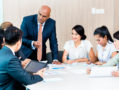 Diversity and Inclusion are (Rightly) the Latest Buzz in the Corporate World A diverse group of professionals sitting around a table brainstorming ideas.