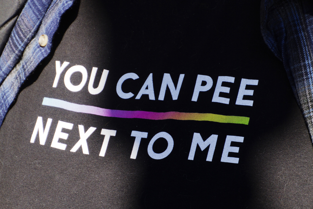 A shirt that reads, "You can pee next to me."