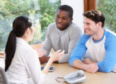 How to File Taxes as a Same-Sex Couple A gay couple consulting with a tax expert.