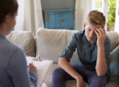 Massachusetts Bans Gay Conversion Therapy for Minors A teenage boy being counseled by a female therapist.