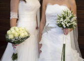 Former Miss America Winner Marries Longtime Girlfriend Two women in white wedding gowns holding bouquets.
