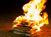 Donations Pour In After Man Burns LGBT Books A stack of book on fire.