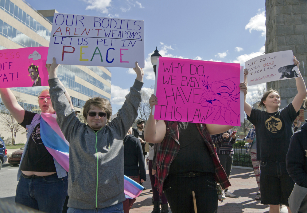 A line of protesters holding up anti-HB2 signs.